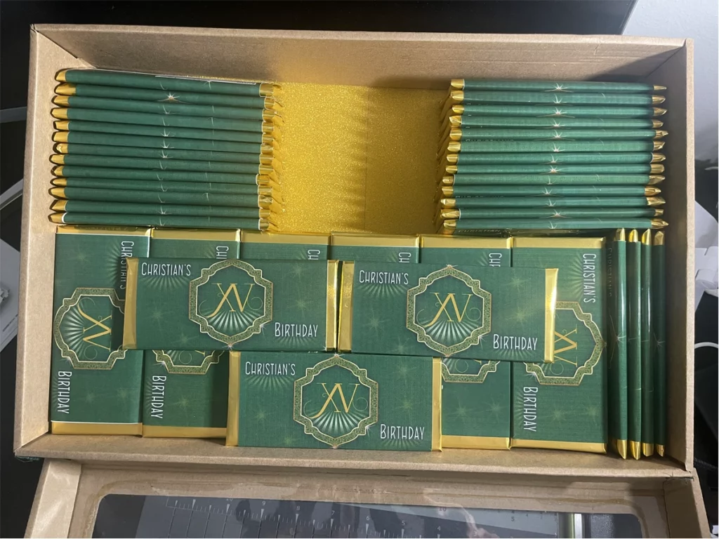 Custom green and gold chocolate bar party favors for a birthday celebration